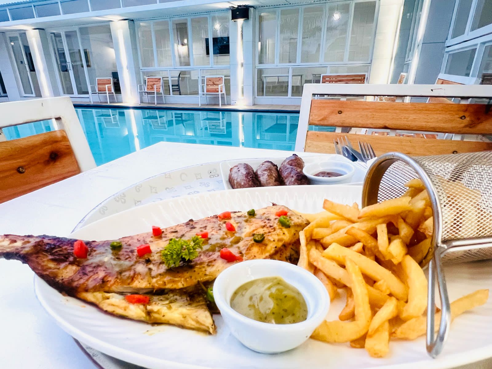 A plate of grilled angel fish with lemon butter sauce and vegetables