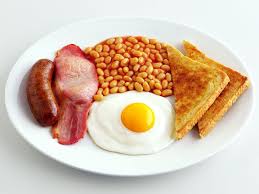 A breakfast platter with eggs, bacon, sausage, and toast