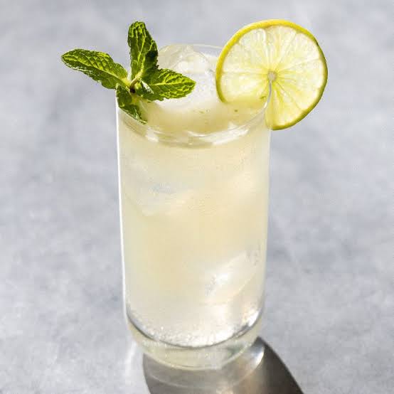 A glass of Mojito cocktail with mint and lime