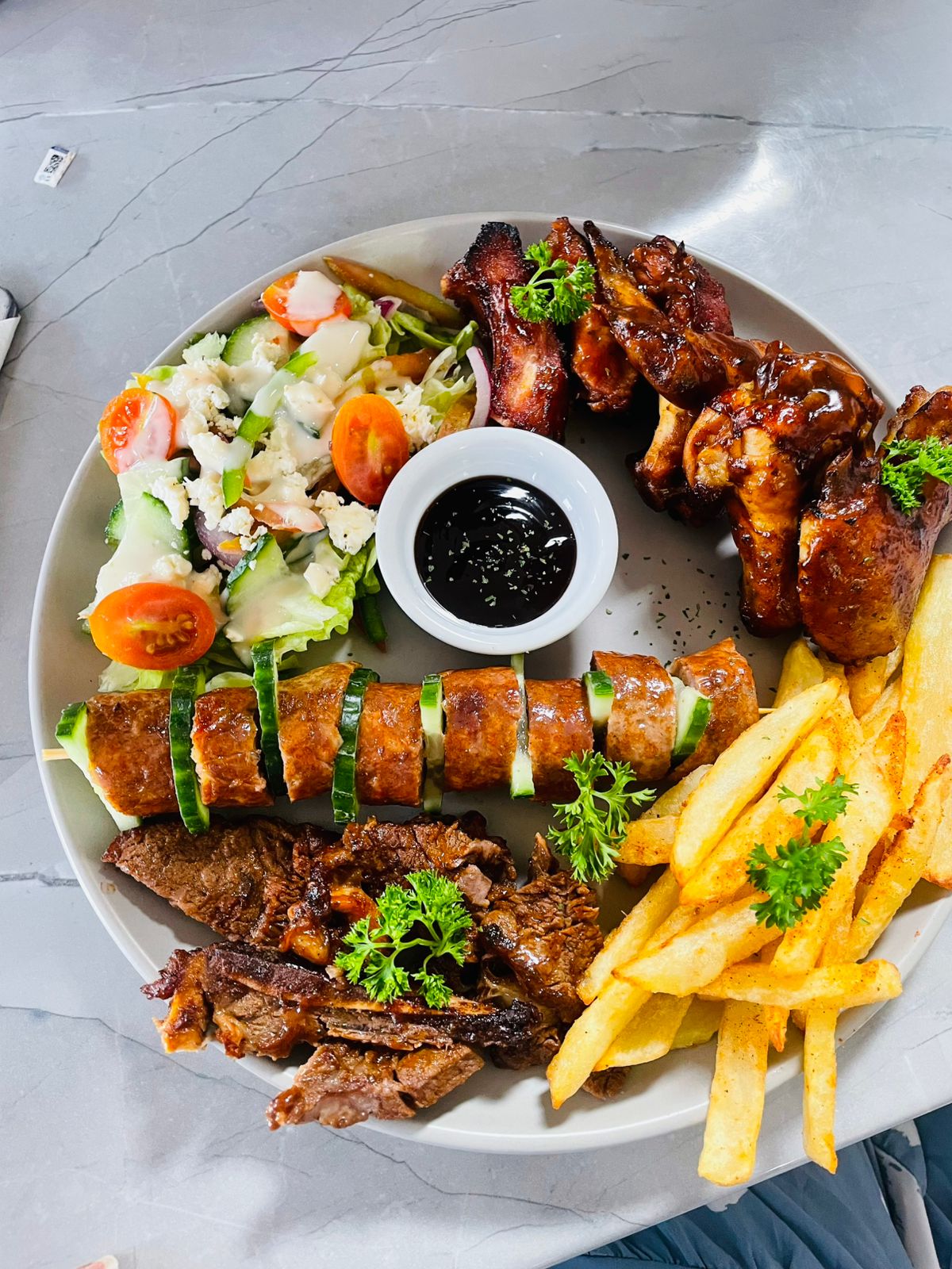 A platter for two with various meats and cheeses