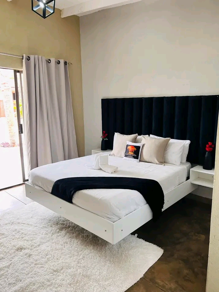 A luxurious Deluxe Room with a spacious bed and modern decor